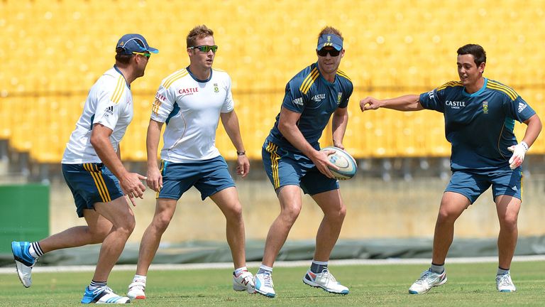 South African captain AB de Villiers (2R) and teammates David Miller (2L), Jacques Kallis (L) and Quinton de Kock play a game of rugby during a practice se