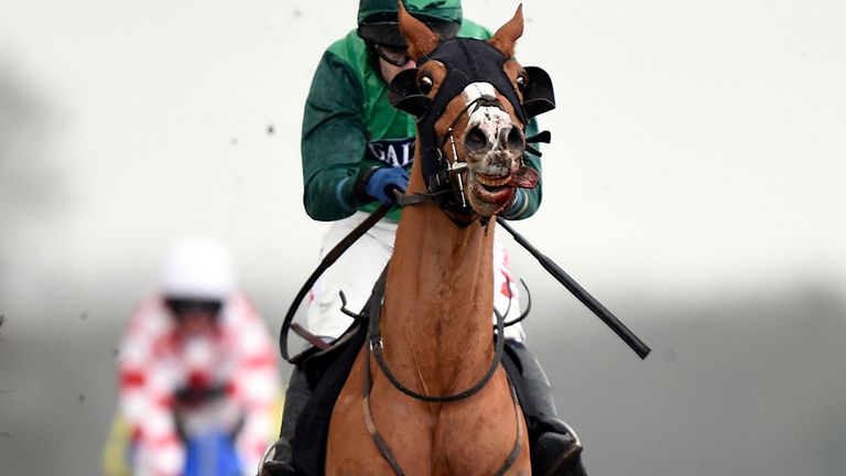 Ainsi Fideles ridden by jockey Tom Scudamore jumps the last to go on and win the racinguk.com Reynoldstown Novices' Chase at Ascot.