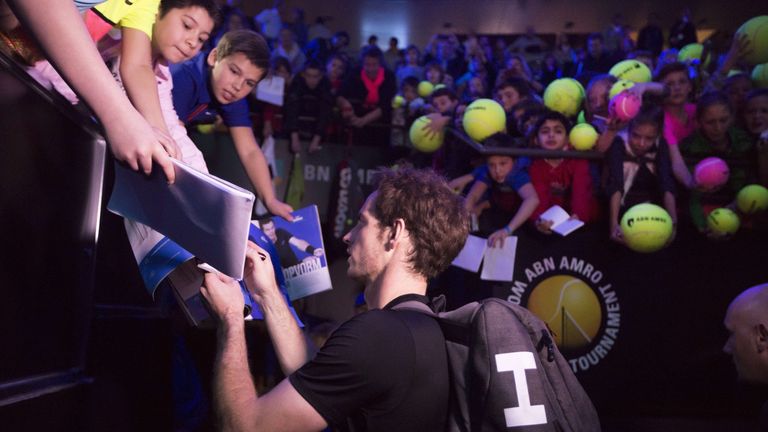 Great Britain's Andy Murray gives autographs at the end of his first round match against Nicolas Mahut at the ABN AMRO World Tennis Tournament in Rotterdam