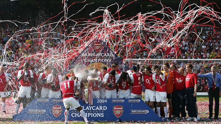 Sylvain Wiltord of Arsenal sprays his teammates with champagne as they celebrate winning the Premiership 
