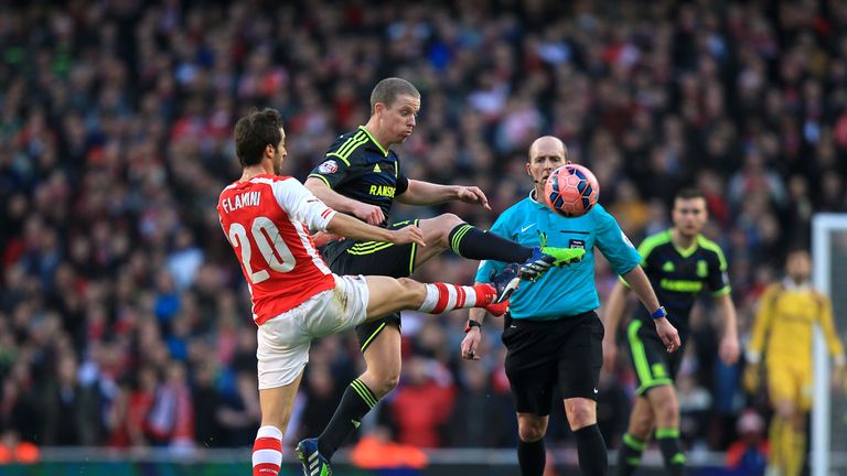 Arsenal's Mathieu Flamini and Middlesbrough's Grant Leadbitter (centre) battle for the ball during the FA Cup Fifth Round match at the Emirates Stadium