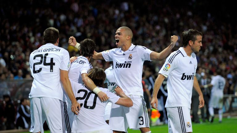 MADRID, SPAIN - OCTOBER 18:  Gonzalo Higuain #20 of Real Madrid celebrates with Rafael Van Der Vaart (R) and Pepe #3 after scoring Real's second goal durin