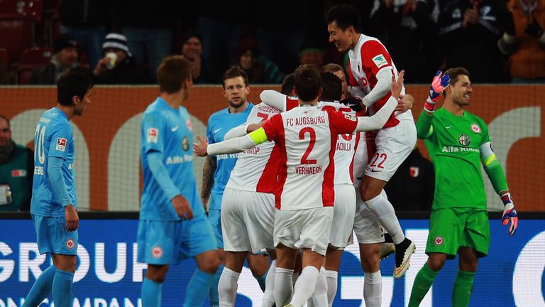 Ragnar Klavan of Augsburg celebrates his team's first goal with team mates during the Bundesliga match between FC Augsburg and Eintracht Frankfurt 