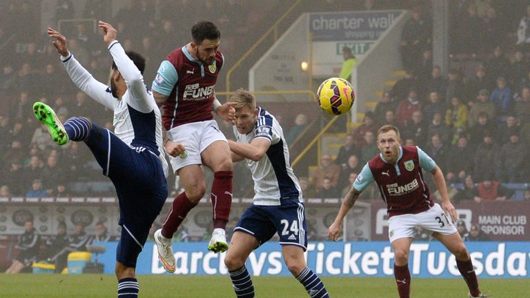 Danny Ings jumps highest to double Burnley's advantage.