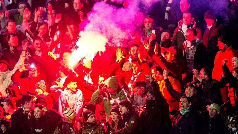 Celtic fans in Zagreb with one of them holding a flare