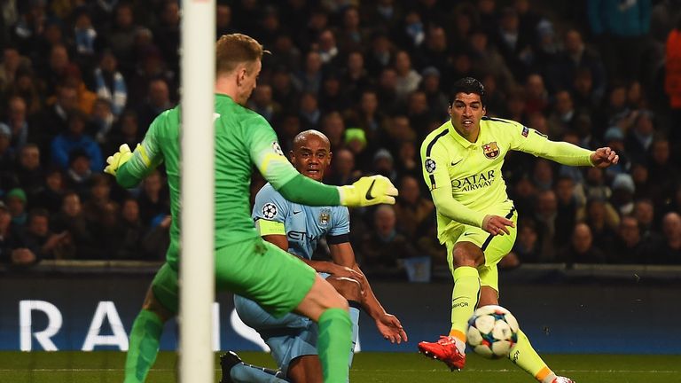 Luis Suarez of Barcelona scores the opening goal past Joe Hart of Manchester City during the UEFA Champions League Roun