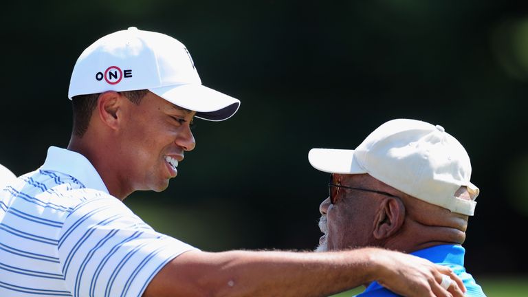 AKRON, OH - AUGUST 05:  Tiger Woods of USA speaks with Charlie Sifford the first African American inducted into the World Golf Hall of Fame during a practi