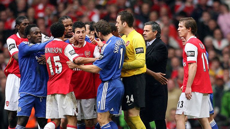 Chelsea manager Jose Mourinho enters the field to help stop a fight between his players and Arsenal's during the League Cup