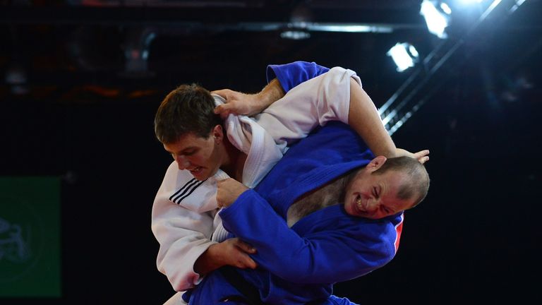 Scotland's gold medalist Christopher Sherrington (R) fights South Africa's Ruan Snyman (L) in the men's judo +100kg class final at the SECC Precinct during