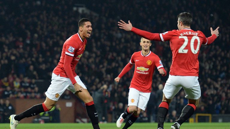 Manchester United's Chris Smalling (L) celebrates with  Robin van Persie and Adnan Januzaj (C)