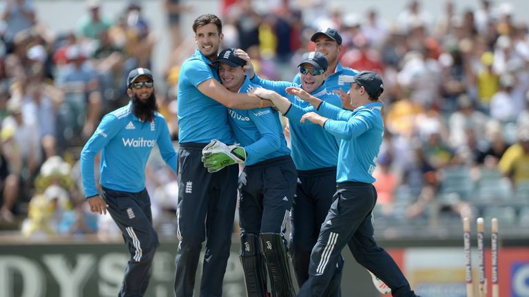 PERTH, AUSTRALIA - FEBRUARY 01:  Jos Buttler of England is mobbed by teammates Steven Finn and Eoin Morgan after running out Mitchell Marsh of Australia du
