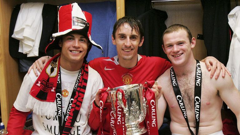 Cristiano Ronaldo, Gary Neville and Wayne Rooney of Manchester United pose with the Carling Cup trophy 