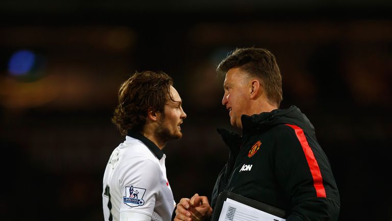 Daley Blind shakes hands with manager Louis van Gaal of Manchester United after the Premier League match at West Ham