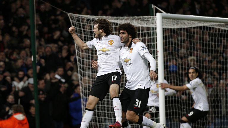 Daley Blind celebrates with Marouane Fellaini after scoring in injury-time.
