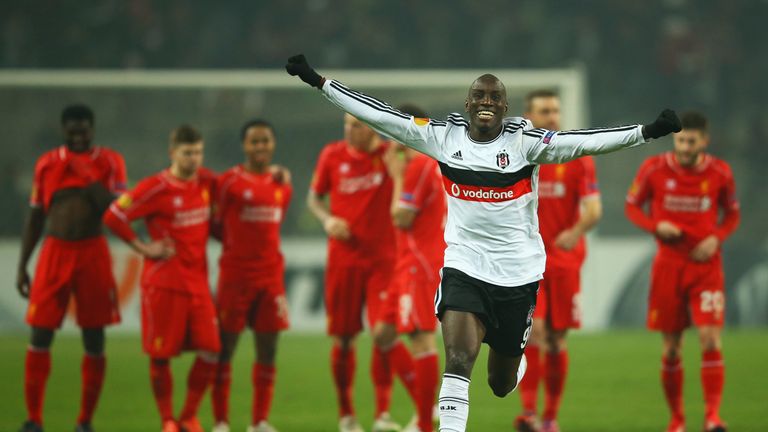 Liverpool players look dejected as Demba Ba celebrates