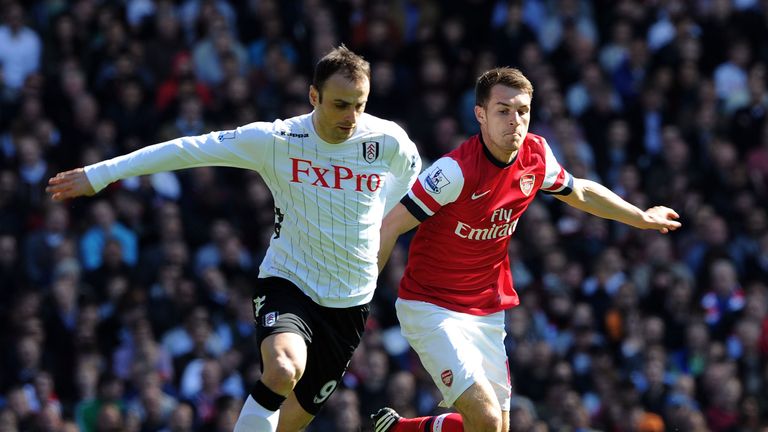 Dimitar Berbatov and Aaron Ramsey in action in the Premier League match between Fulham and Arsenal at Craven Cottage on April 20, 2013