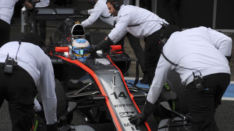 Fernando Alonso is pushed back into the pits