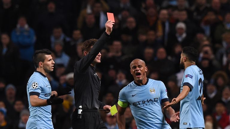 German referee Felix Brych (2L) shows a red card to send off Manchester City's French defender Gael Clichy (R) for a second bookable offence
