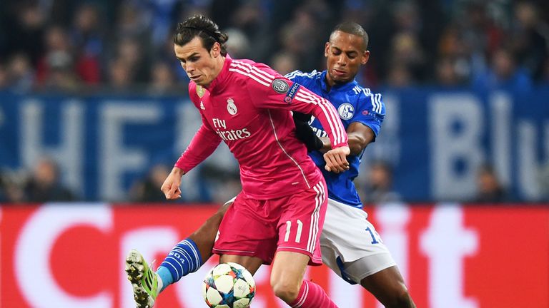 Gareth Bale is challenged by Dennis Aogo