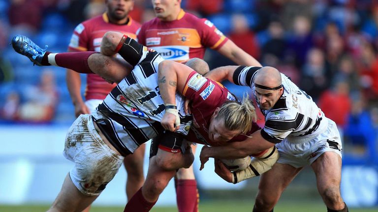 Hull FC's Gareth Ellis and Danny Houghton tackle Huddersfield's Eorl Crabtree 