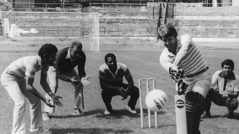 Members of the West Indian cricket team fielding as English footballer Geoff Hurst tries his hand at batting a football at Chelsea's Stamford Bridge ground