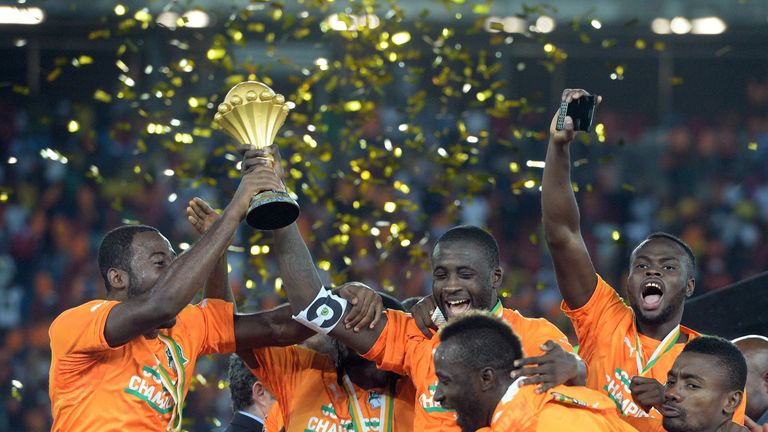 Ivory Coast's players celebrate with the trophy at the end of the 2015 African Cup of Nations final football match between Ivory Coast and Ghana