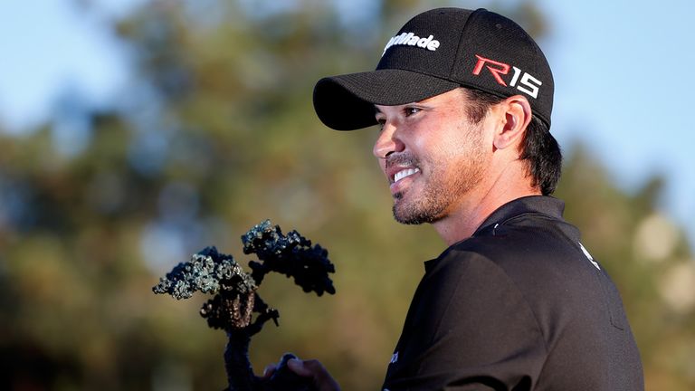Jason Day poses with the championship trophy after his victory at the Farmers Insurance Open at Torrey Pines South