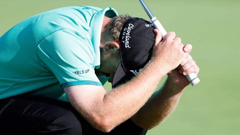 JB Holmes reacts after missing a birdie putt on the 18th green during the final round of the Farmers Insurance Open