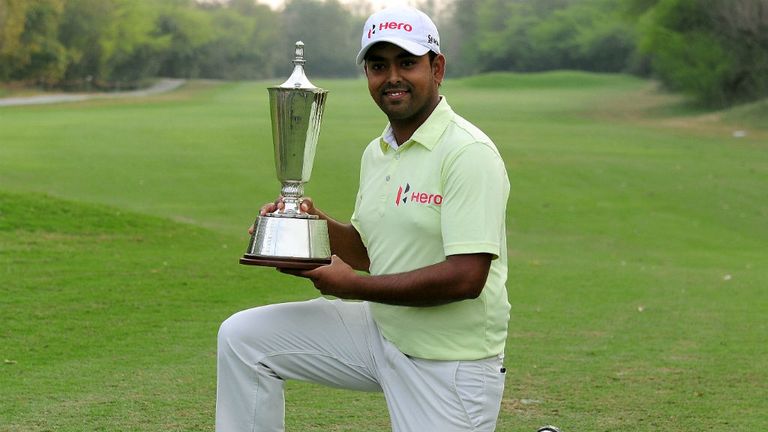 Indian golfer Anirban Lahiri poses with the trophy after winning the Indian Open golf tournament in New Delhi