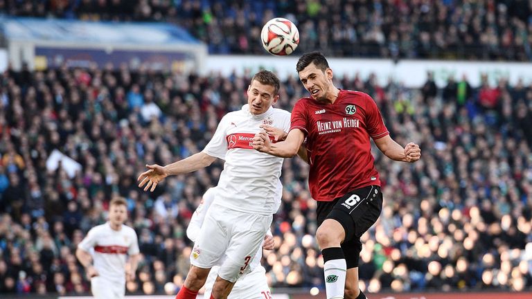 HANOVER, GERMANY - FEBRUARY 28:  Ceyhun Guelselam of Hannover is challenged by Daniel Schwab of Stuttgart 