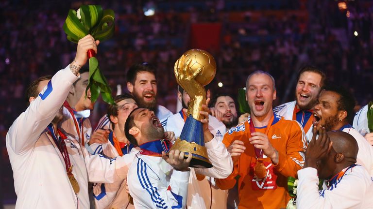 Michael Guigou of France lifts the trophy on the podium after the final match between Qatar and France in the Men's Handball World Championship