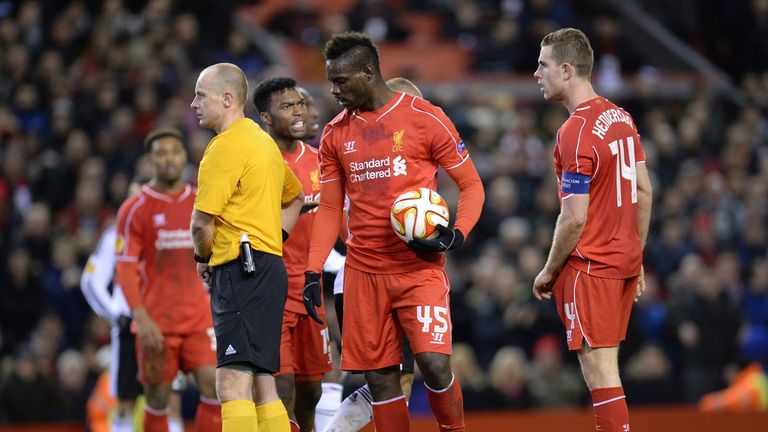 Liverpool's Mario Balotelli (C) holds the ball before placing it on the spot to take the kick and score after taking it from Jordan Henderson