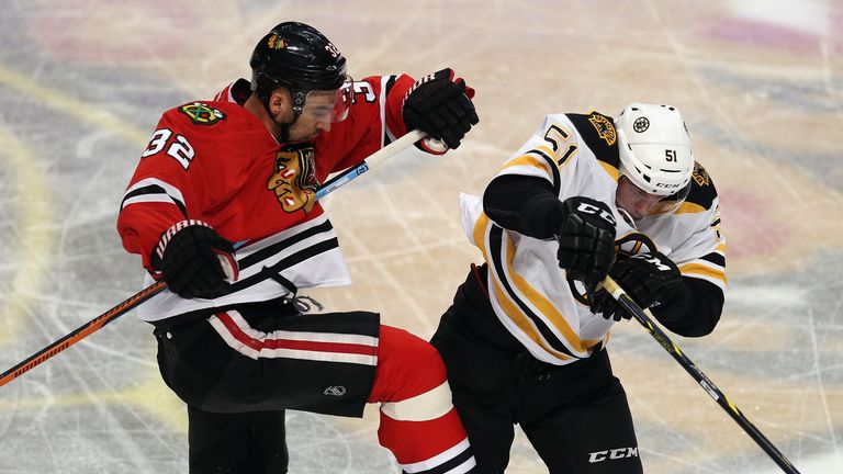 Michal Rozsival of the Chicago Blackhawks collides with Ryan Spooner of the Boston Bruins at the United Center on Februa