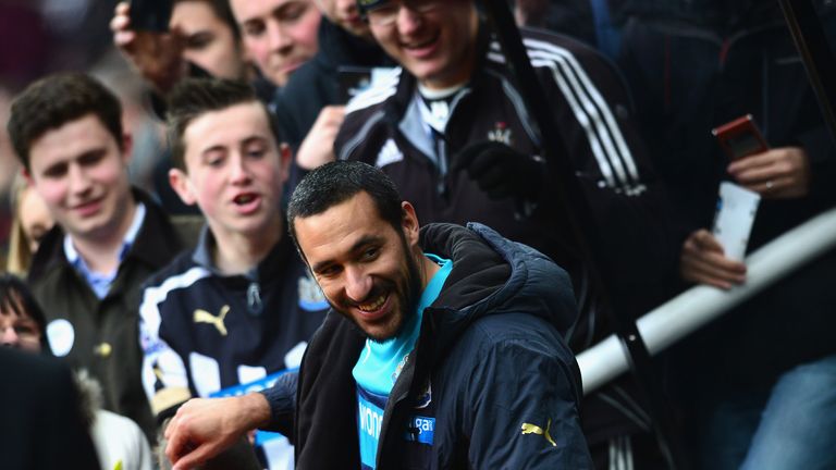 Jonas Gutierrez of Newcastle United is greeted by fans as he take his seat in the dug out during the game against Aston Villa