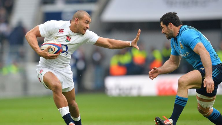 England's centre Jonathan Joseph (L) raises a hand to hand off Italy's centre Andrea Masi (R)