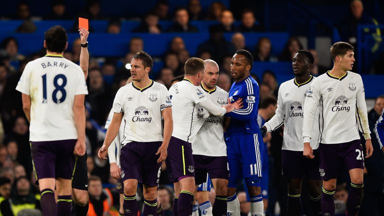 Referee Jonathan Moss shows Everton's Gareth Barry a red card