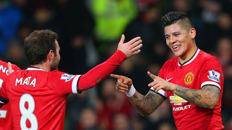 Juan Mata of Manchester United congratulates Marcos Rojo 