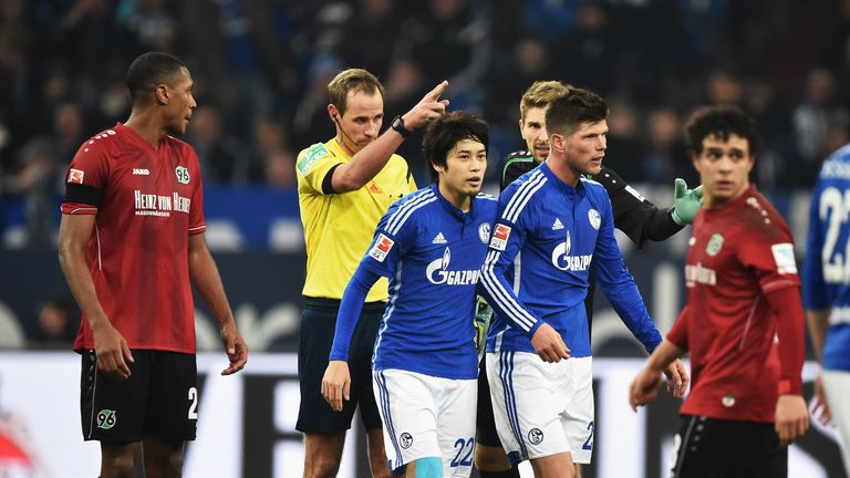 Referee Sascha Stegeman tells  Klaas - Jan Huntelaar of Schalke to leave the pitch after giving him a red card for his tackle on Manuel Schmeidebach 