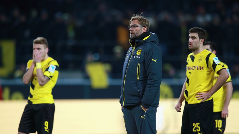 Juergen Klopp reacts with his players Ciro Immobile (L) and Sokratis after Dortmund's loss to Augsburg.