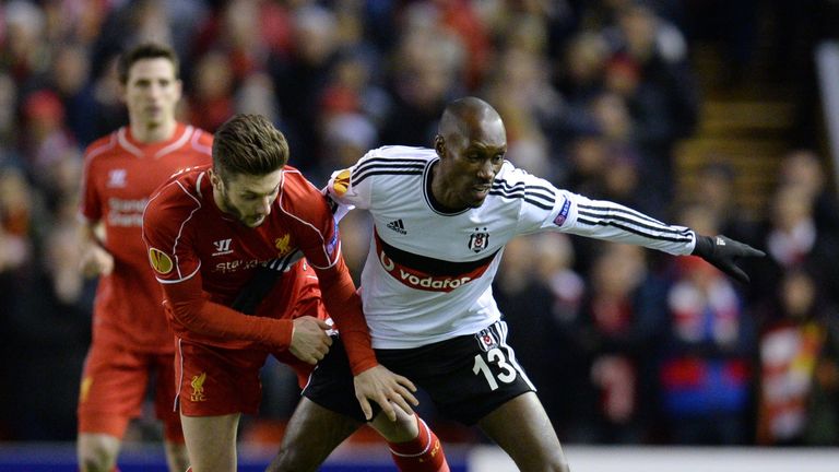 Liverpool midfielder Adam Lallana (C) vies for the ball with Besiktas midfielder Atiba Hutchinson (R)