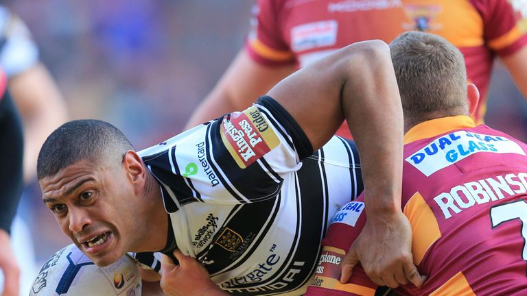 Hull FC's Leon Pryce is tackled by Huddersfield's Luke Robinson (right) during the First Utility Super League match at the John Smith's Stadium