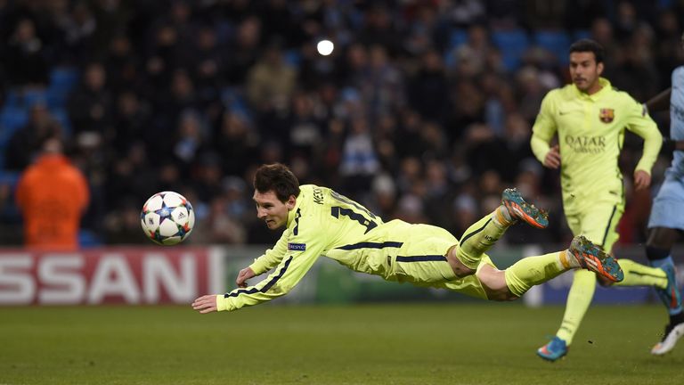 Barcelona's Lionel Messi heads the ball