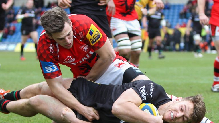 Alex Lewington of London Irish scores a try under pressure from Nick Scott of London Welsh