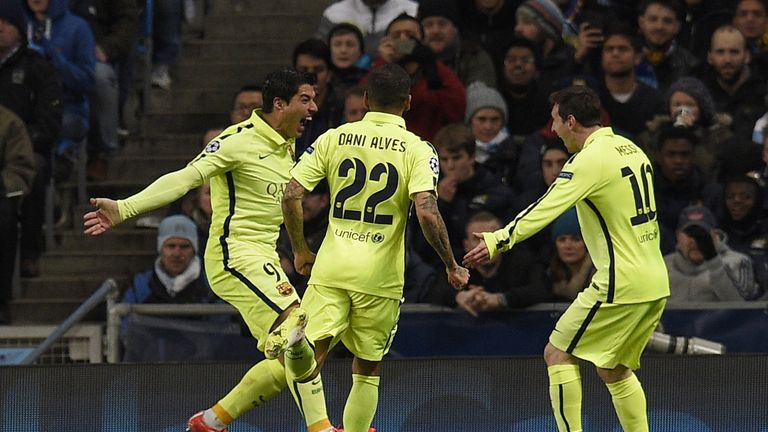 Luis Suarez celebrates scoring the opening goal with Dani Alves and Lionel Messi during the Champions League  match between Manchester City and Barcelona