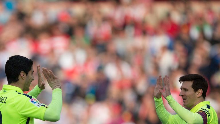 GRANADA, SPAIN - FEBRUARY 28:  Lionel Messi (R) of FC Barcelona celebrates scoring their third goal with teammate Luis Suarez (L) during the La Liga match 