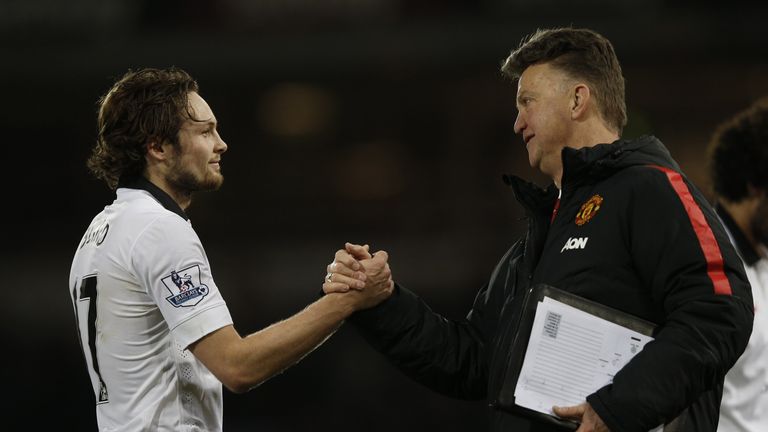 Louis van Gaal (R) shakes hands with goal-scorer Manchester United's Dutch midfielder Daley Blind
