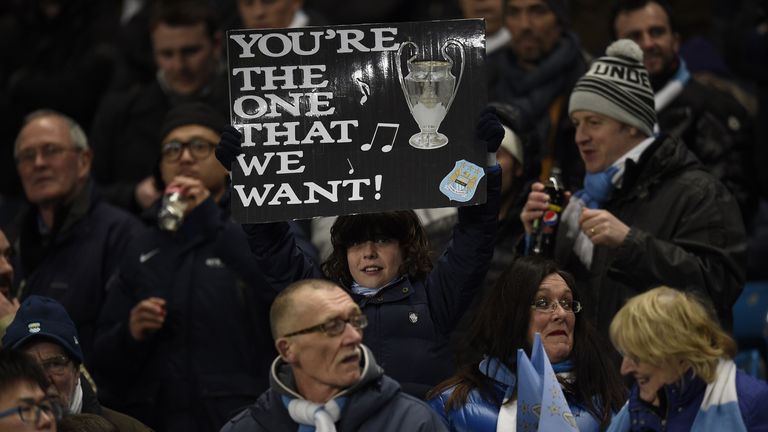 A Manchester City fan holds up a sign as they wait for kick off of the Champions League match between Manchester City and Barcelona