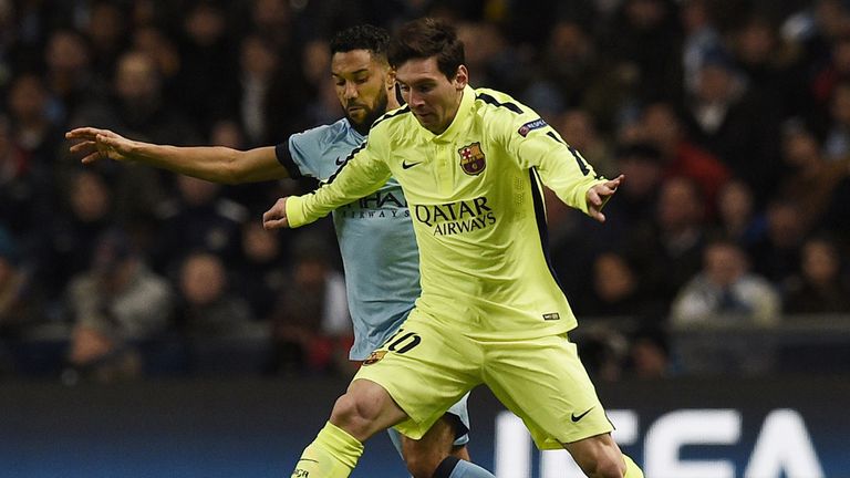 Lionel Messi holds off Gael Clichy