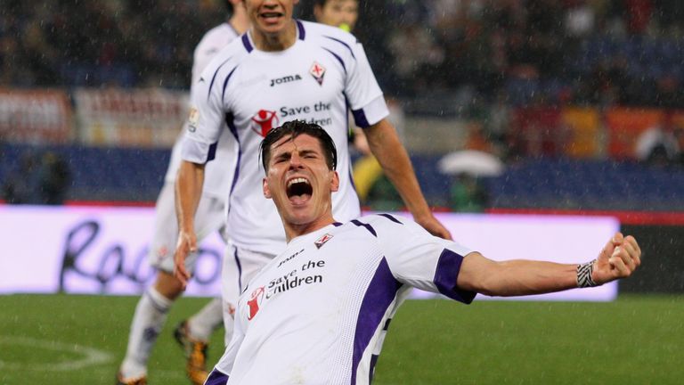 Mario Gomez celebrates scoring his second goal against Roma