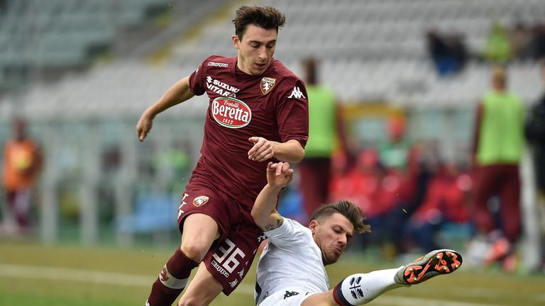 Matteo Darmian is tackled by Daniele Dessena 